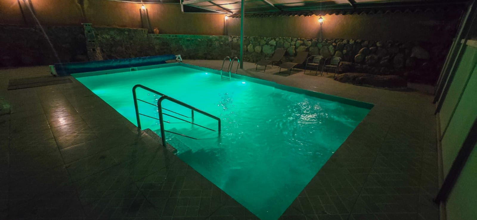 Private pool illuminated at night
